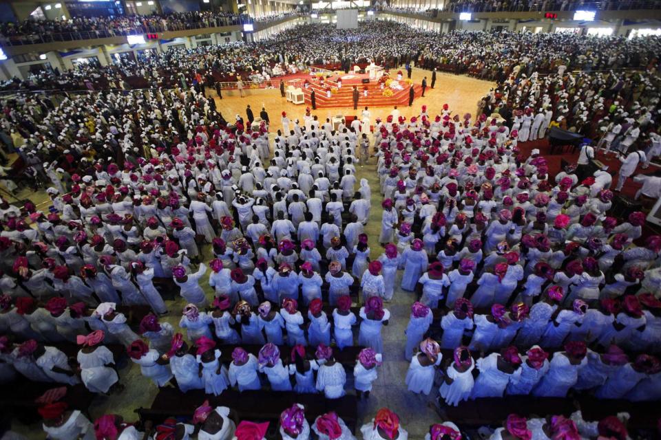 Worshippers, dressed in traditional attires, attend a church service at the Living Faith Church, also known as the Winners' Chapel, in Ota district, Ogun state, some 60 km (37 miles) outside Nigeria's commercial capital Lagos September 28, 2014. Hundreds of millions of dollars change hands each year in Nigeria's popular Pentecostal "megachurches", which are modelled on their counterparts in the United States. Some of these churches can hold more than 200,000 worshippers and, with their attendant business empires, they constitute a significant section of the economy, employing tens of thousands of people and raking in tourist dollars, as well as exporting Christianity globally. To match Insight NIGERIA-MEGACHURCHES/ Picture taken September 28, 2014. REUTERS/Akintunde Akinleye (NIGERIA - Tags: RELIGION BUSINESS)