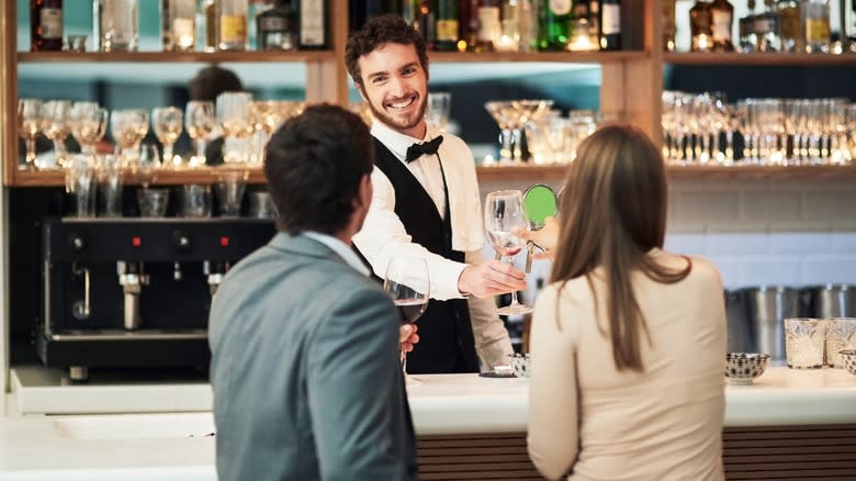 Customers interacting with bartender 