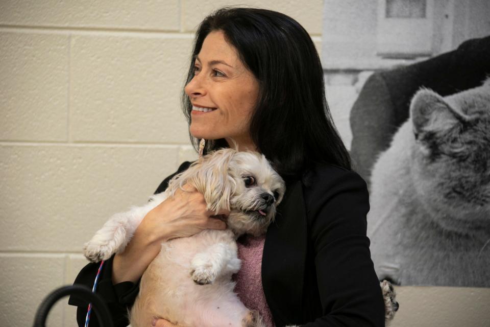 Michigan Attorney General Dana Nessel holds Gucci a 10-year-old shihtzu Thursday, April 18, 2019 during a media availability with adoptable dogs from the Michigan Humane Society to bring attention to the importance of recognizing and stopping puppy scams in the state.  