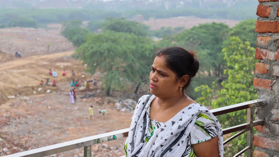 Savita looks over what was once her home of seven years.  - Rhea Mogul/CNN