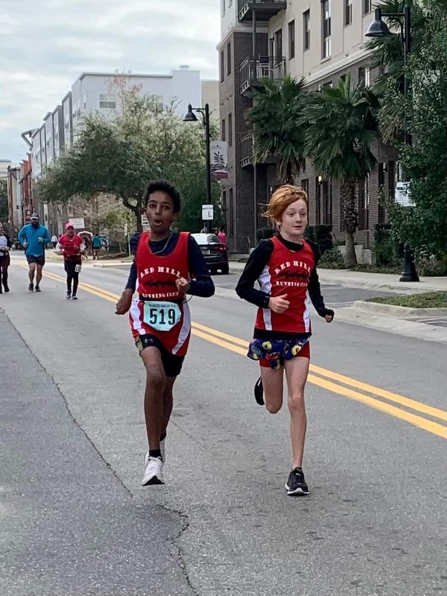 Two young members of the Red Hills Running Club/winning relay team in Sunday's Tallahassee Marathon.