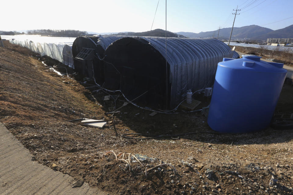 This photo shows dormitories draped with black sunblock nets for migrant workers at a farm in Pocheon, South Korea on Feb. 8, 2021. In the town near South Korea’s capital, hundreds of migrant workers from across Asia toil isolated and unprotected by labor laws. (AP Photo/Ahn Young-joon)