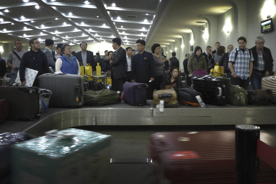 FILE - In this Oct. 21, 2014, file photo, passengers wait for their luggage upon arrival at the Sunan International Airport in Pyongyang, North Korea. North Korea banned foreign tourists to guard against the spread of a new virus from China, a tour operator said. The temporary closing of the North Korean border would begin Wednesday, Jan. 22, 2020. (AP Photo/Wong Maye-E, File)