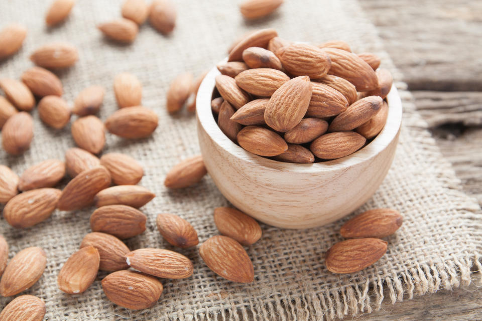 group of almonds  from wood bowl on wood background (Getty Images)