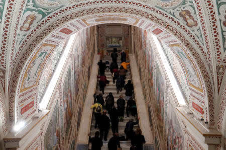 Worshippers pray on the Holy Stairs in Rome, Italy April 16 2019. REUTERS/Remo Casilli