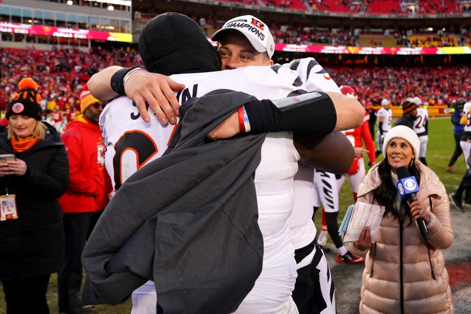 Cincinnati Bengals quarterback Joe Burrow (9) hugs Cincinnati Bengals guard Quinton Spain (67) at the conclusion of the AFC championship NFL football game, Sunday, Jan. 30, 2022, at GEHA Field at Arrowhead Stadium in Kansas City, Mo. The Cincinnati Bengals defeated the Kansas City Chiefs, 27-24, to advance to the Super Bowl. 