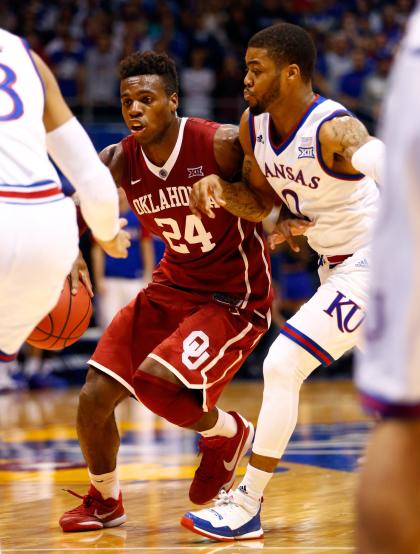 Frank Mason III guards Oklahoma's Buddy Hield as he drives the lane on Monday. (Getty)