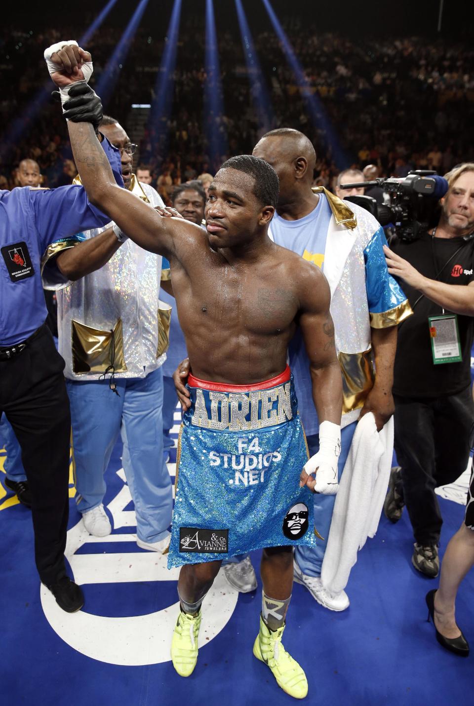 Adrien Broner celebrates his unanimous decision victory over Carlos Molina in their WBA super lightweight title boxing fight Saturday, May 3, 2014, in Las Vegas. (AP Photo/Eric Jamison)