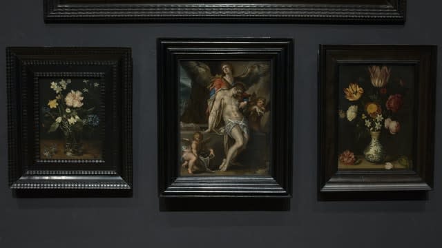 Bartholomeus Spanger’s Body of Christ Supported by Angels oil on copper painting, centre, which went on display at the Rijksmuseum (Peter Dejong/AP)