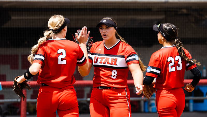 Utah pitcher Mariah Lopez (8) high-fives teammates Utah infielder Ellessa Bonstrom (2) and Utah infielder Aliya Belarde (23) during the third game of the NCAA softball Super Regional between Utah and San Diego State at Dumke Family Softball Stadium in Salt Lake City on Sunday, May 28, 2023.