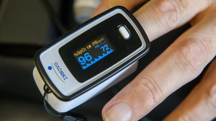 A man checks his blood oxygen level with a fingertip pulse oximeter. (Photo: Matt Dayhoff/Journal Star/ USA TODAY NETWORK)