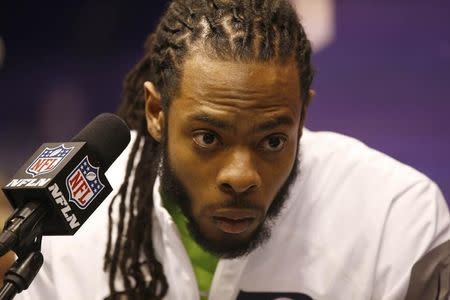 Jan 27, 2015; Phoenix, AZ, USA; Seattle Seahawks cornerback Richard Sherman reacts during media day for Super Bowl XLIX at US Airways Center. Mandatory Credit: Rob Schumacher-Arizona Republic via USA TODAY Sports