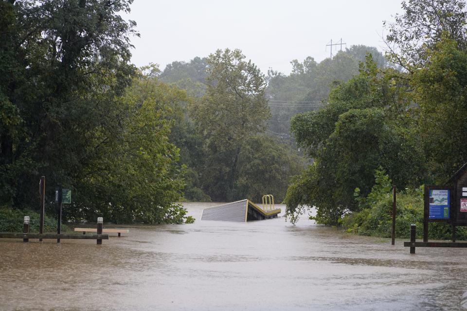 The French Broad River rises above its banks in the River Arts District on Friday, September 26. Hurricane Helene is bringing heavy rains to Asheville.