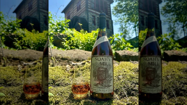 Noah's Mill bourbon bottle with glass