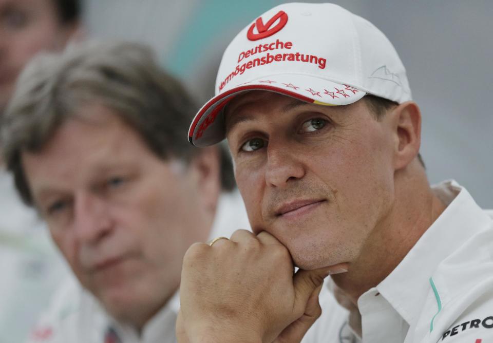 FILE - This is a Thursday, Oct. 4, 2012 file photo of Mercedes driver Michael Schumacher, right, of Germany sits with teammate Norbert Haug, during a news conference to announce his retirement from Formula One at the end of the 2012 in Suzuka, Japan. Michael Schumacher's manager said Friday April 4, 2014 that the retired Formula One star now "shows moments of consciousness and awakening," more than three months after suffering serious head injuries in a skiing accident. Manager Sabine Kehm said in a statement that "Michael is making progress on his way." She added that "we keep remaining confident." (AP Photo/Shizuo Kambayashi, File)