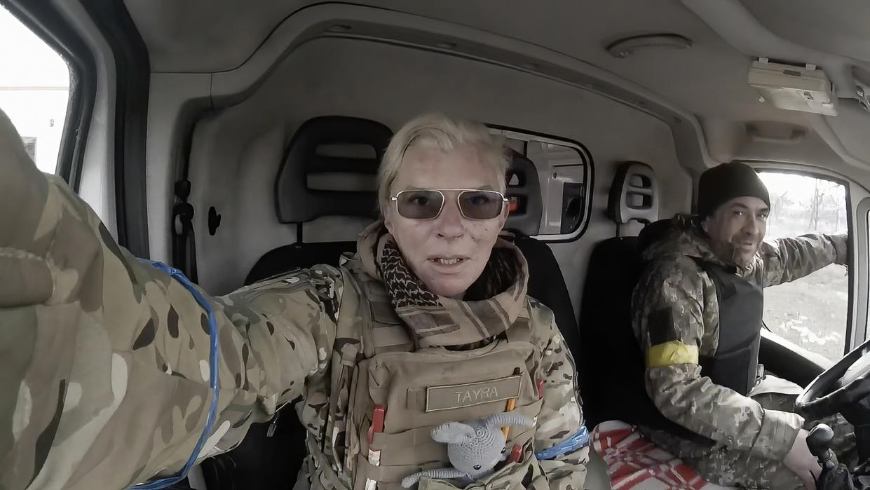 Yuliia Paievska and her driver, Serhiy, sit in a vehicle in Mariupol on March 9. She last appeared on March 21 on Russian television as a captive, handcuffed and with bruises on her face.