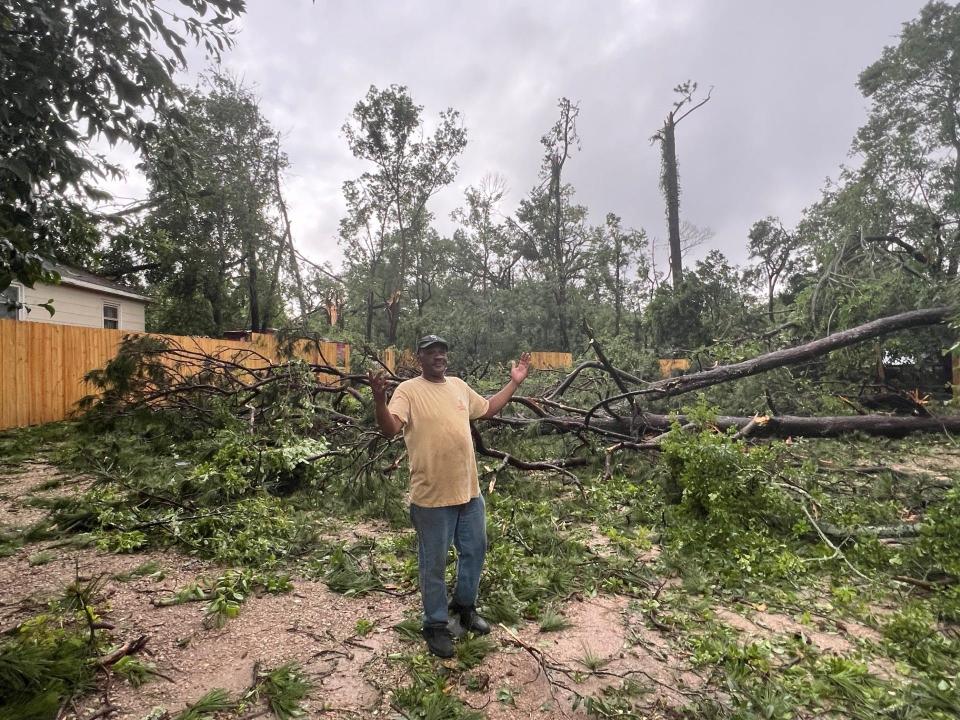 Mark Francis in his backyard littered with tree debris after a wind event, Friday May 10, 2024