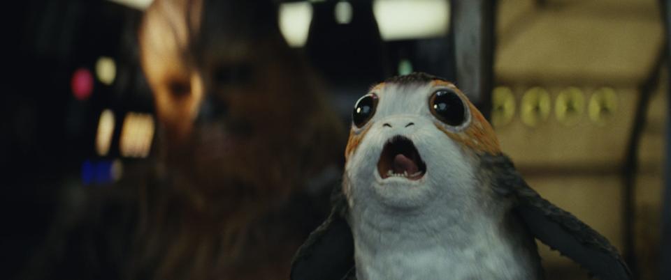 Even with Chewbacca (left) by his side, a porg freaks out in the cockpit of the Millennium Falcon when trouble arises in "Star Wars: The Last Jedi."