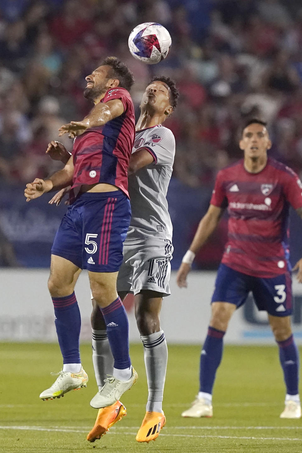FC Dallas midfielder Facundo Quignon (5) and Sporting Kansas City forward Khiry Shelton (11) jump for the header during the first half of an MLS soccer match Saturday, May 6, 2023, in Frisco, Texas. (AP Photo/LM Otero)