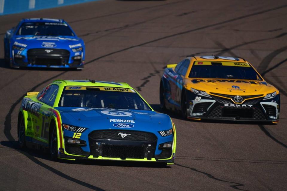 Nov 5, 2023; Avondale, Arizona, USA; NASCAR Cup Series driver Ryan Blaney (12) races for position against driver Christopher Bell (20) during the Cup Series Championship race at Phoenix Raceway. Mandatory Credit: Gary A. Vasquez-USA TODAY Sports Gary A. Vasquez/Gary A. Vasquez-USA TODAY Sports