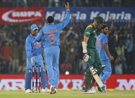 India's captain Mahendra Singh Dhoni (L) celebrates with team mates after winning the second one-day international cricket match against South Africa in Indore, India, October 14, 2015. REUTERS/Danish Siddiqui