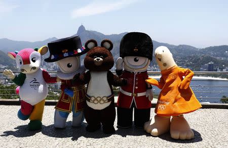 Mascots from other editions of the Summer Olympic Games (L-R) Fu Niu Lele (Beijing 2008), Wenlock (London 2012), Misha (Moscow 1980), Mandeville (London 2012) and Athena (Athens 2004) pose for a picture on top of Sugar Loaf mountain in Rio de Janeiro November 21, 2014. REUTERS/Sergio Moraes