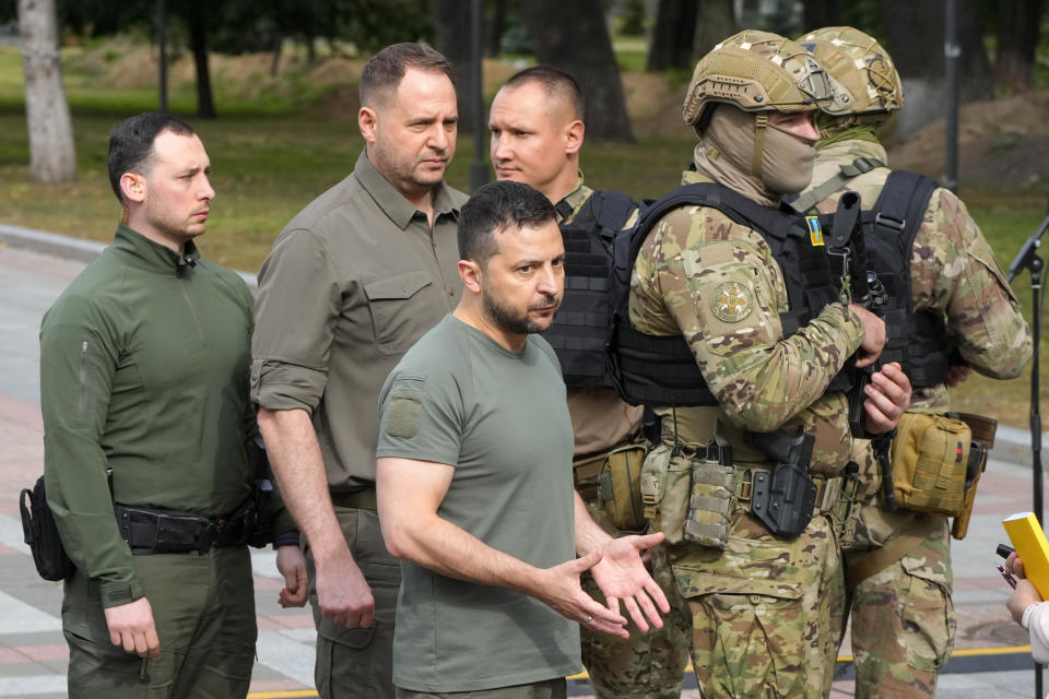 Ukrainian President Volodymyr Zelenskyy, center, reacts after his press conference in Kyiv, Ukraine, Friday, Sept. 9, 2022. (AP Photo/Efrem Lukatsky)