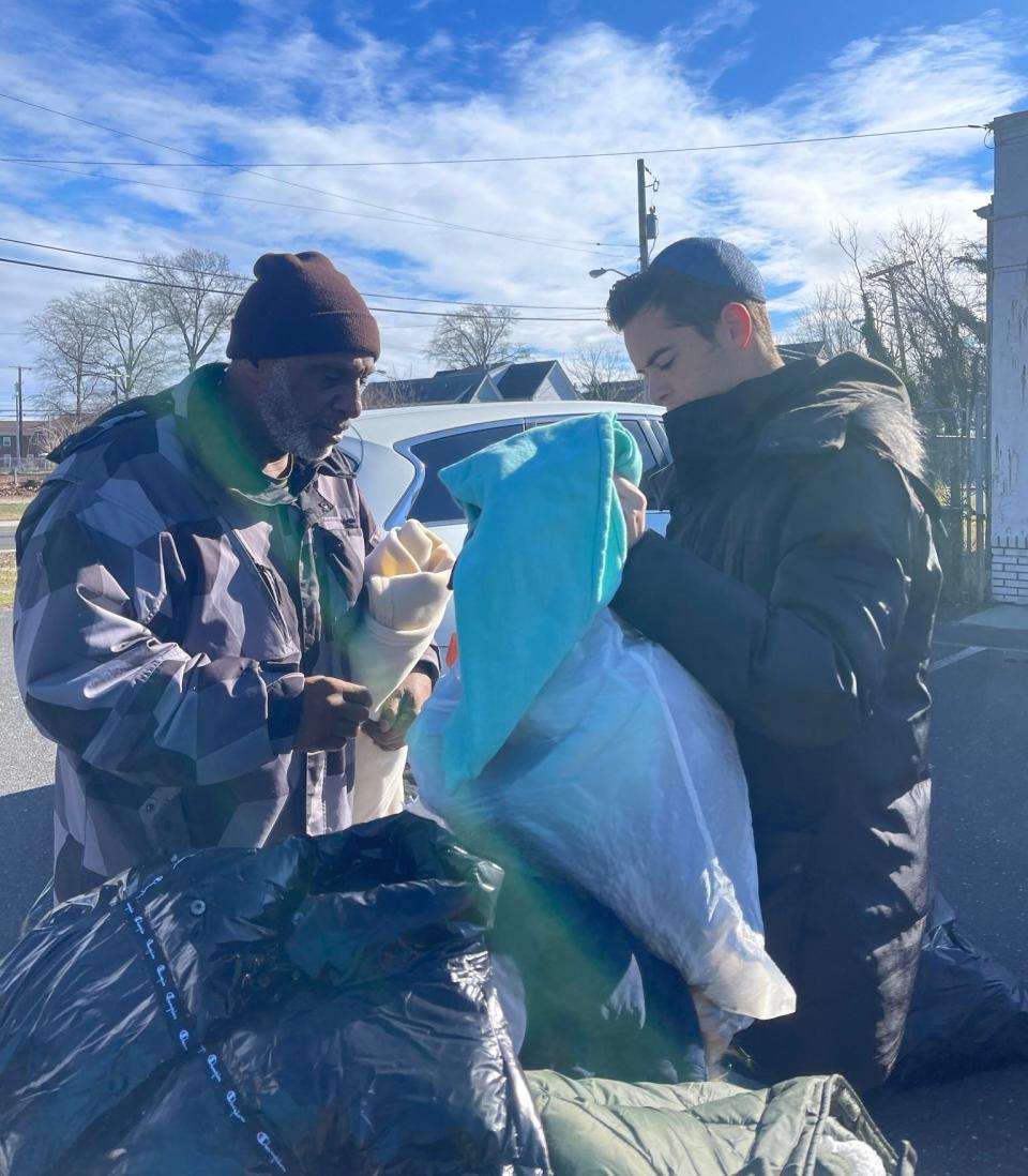 Zac Levy (right) during a Project Unhoused clothing distribution.