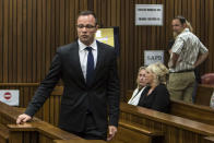 Oscar Pistorius, left, walks past June Steenkamp, back left, mother of Reeva Steenkamp, and Jenny Strydom, as he arrives in court Monday, March 17, 2014 in Pretoria, South Africa. Pistorius is on trial for the murder of his girlfriend Reeva on Valentines Day 2013. (AP Photo/Daniel Born, Pool)