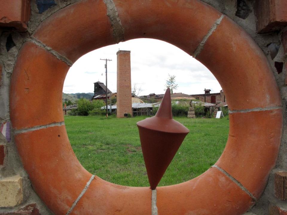 This June 4, 2013 photo shows a view through the Potter's Shrine to shuttered beehive kilns at the Archie Bray Foundation for the Ceramic Arts near Helena, Mont. The foundation offers artist residencies and free self-guided walking tours on the grounds of a former brick factory. (AP photo/Matt Volz)