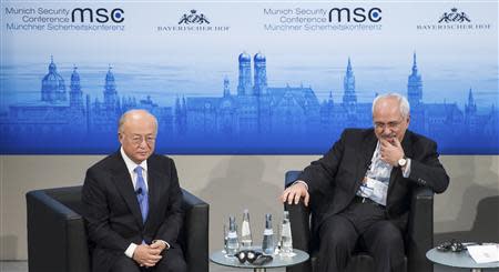 International Atomic Energy Agency (IAEA) Director General Yukiya Amano (L) and Iran's Foreign Minister Mohammad Javad Zarif attend the annual Munich Security Conference February 2, 2014. REUTERS/Lukas Barth