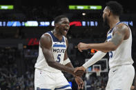 Minnesota Timberwolves guard Monte Morris, right, celebrates with guard Anthony Edwards (5) after making a 3-point shot at the buzzer during the third quarter of the team's NBA basketball game against the Toronto Raptors, Wednesday, April 3, 2024, in Minneapolis. (AP Photo/Abbie Parr)