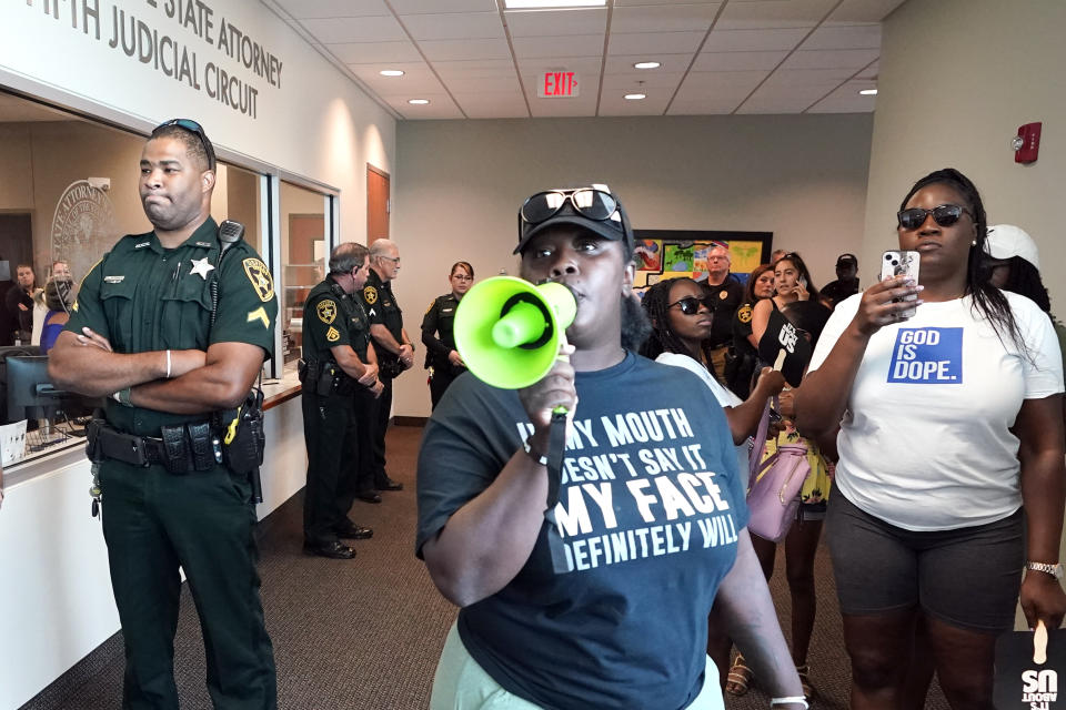 Protesters gather in outside the state attorney's office at the Marion County Courthouse, Tuesday, June 6, 2023, in Ocala, demanding the arrest of a woman who shot and killed Ajike Owens, a 35-year-old mother of four, last Friday night, June 2. Authorities came under intense pressure Tuesday to bring charges against a white woman who killed Owens, a Black neighbor, on her front doorstep, as they navigated Florida’s divisive stand your ground law that provides considerable leeway to the suspect in making a claim of self defense. (AP Photo/John Raoux)