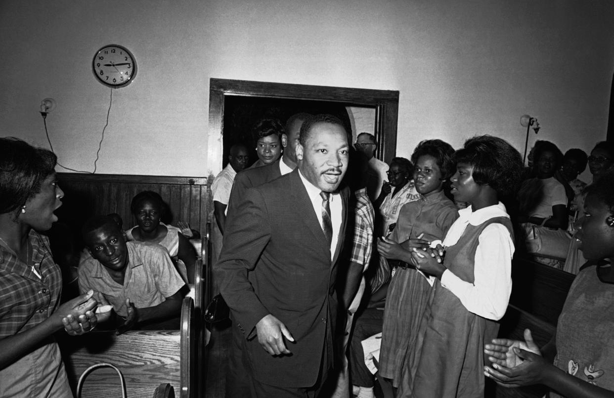 Civil rights protesters sing and clap their hands as Dr. Martin Luther King Jr. enters the First Baptist Church for a mass meeting after returning to St. Augustine on June 16, 1964, to lead the drive to integrate the nation’s oldest city.