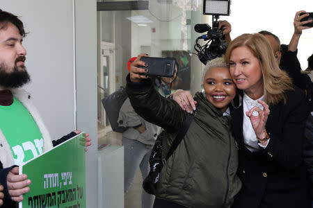 Tzipi Livni, former Israeli foreign minister poses with a supporter for a selfie, after speaking at a news conference in Tel Aviv, Israel February 18, 2019. REUTERS/Ammar Awad