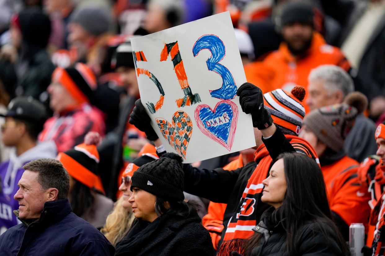 Fans raise signs in support of injured Buffalo Bills player Damar Hamlin in the first quarter of the NFL Week 18 game between the Cincinnati Bengals and the Baltimore Ravens at Paycor Stadium in downtown Cincinnati on Sunday, Jan. 8, 2023. The Bengals led 24-7 at halftime.