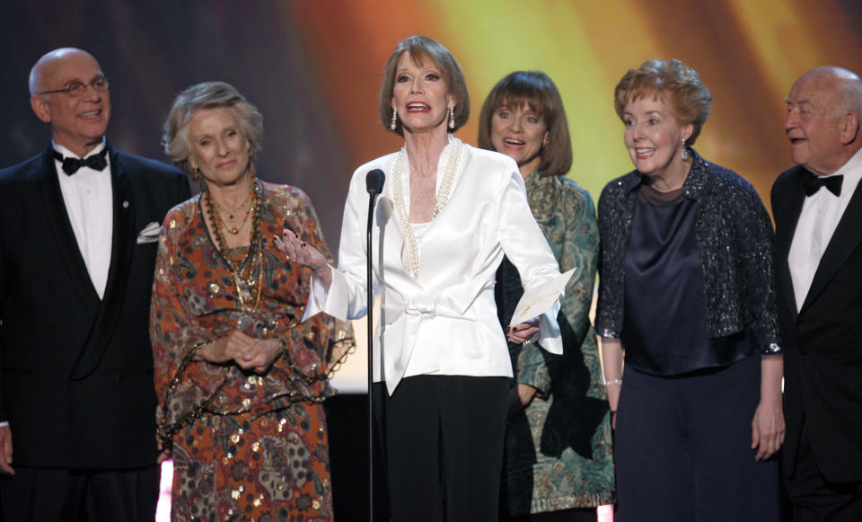 FILE - In this Jan. 2007 file photo, the cast of "The Mary Tyler Moore Show," from left, Gavin MacLeod, Cloris Leachman, Mary Tyler Moore, Valerie Harper, Georgia Engel and Ed Asner, present the award for outstanding performance by an ensemble in a comedy series at the 13th Annual Screen Actors Guild Awards, in Los Angeles. Valerie Harper, who scored guffaws and stole hearts as Rhoda Morgenstern on back-to-back hit sitcoms in the 1970s, has died, Friday, Aug. 30, 2019. She was 80. (AP Photo/Mark J. Terrill, File)