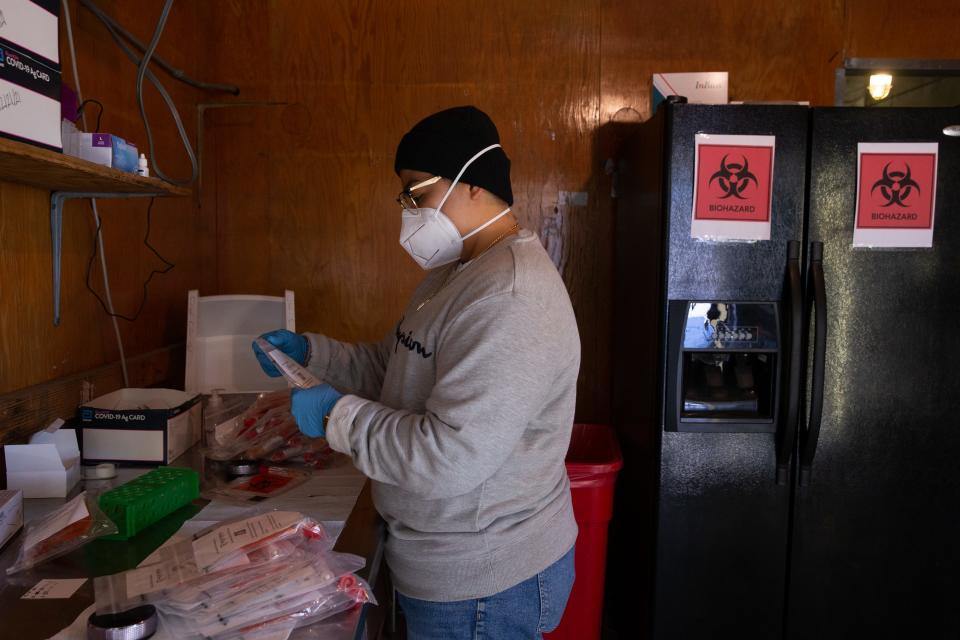 Jennifer Martinez (lab tech) sorts COVID-19 tests on Jan. 4, 2022, at Valley Shield COVID-19 Testing in Phoenix.