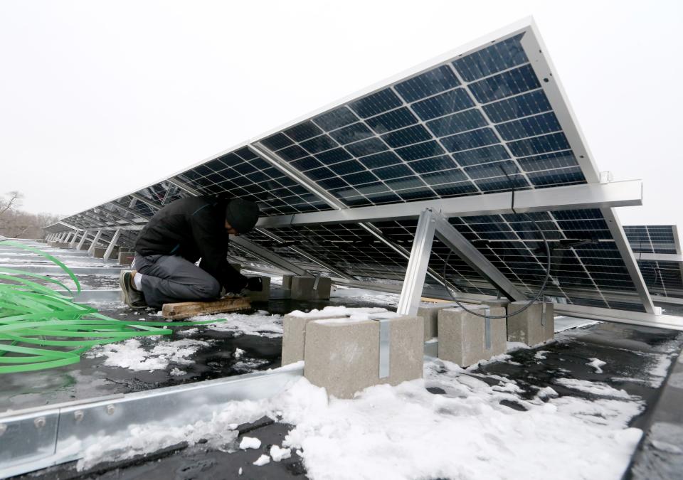 Carl Yoder of Wellspring helps install solar panels that will sit atop the new Paramount School Tuesday, Jan. 24, 2023, at the former Tarkington Elementary School building on Hepler Street in South Bend. The 379 panels will provide 80% of the school’s electric needs, and it is estimated the panels will be paid for in four years.