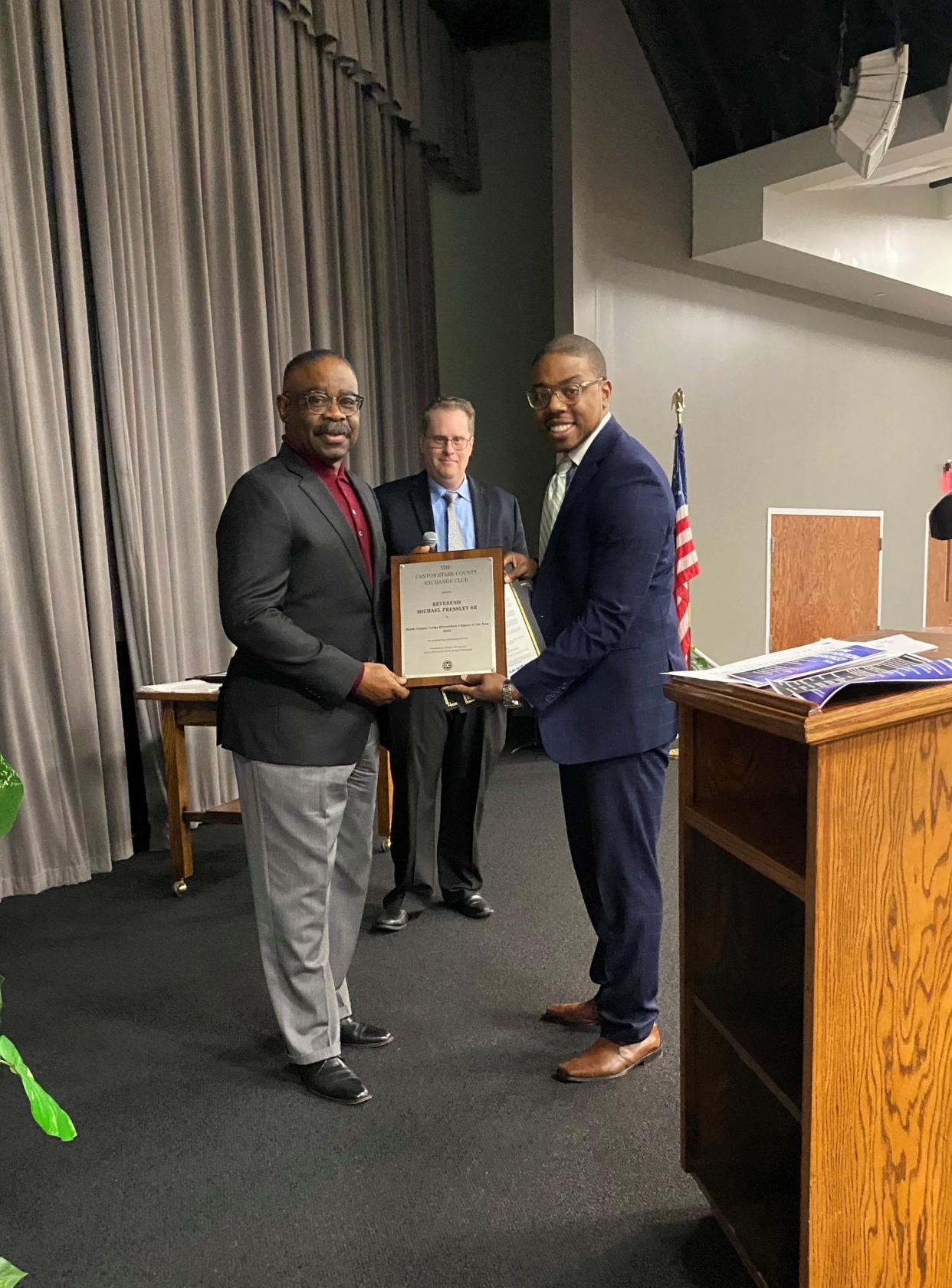 The Rev. Michael Pressley Sr., left, was named the Robert D. Horowitz Crime Prevention Citizen of the Year at Wednesday's Crime Prevention Breakfast sponsored by the Exchange Club of Canton-Stark County. He is standing with Stark County Prosecutor Kyle Stone. James Knight, crime prevention specialist with the county prosecutor's office, is in the background. Knight is secretary of the Exchange Club. He served as master of ceremonies.