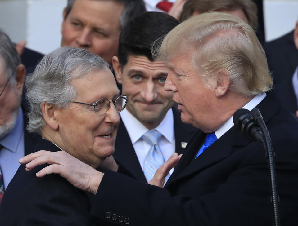 President Trump congratulates Mitch McConnell as Paul Ryan looks on during a celebration of the passage of the tax bill Dec. 20. (Photo: Manuel Balce Ceneta/AP)