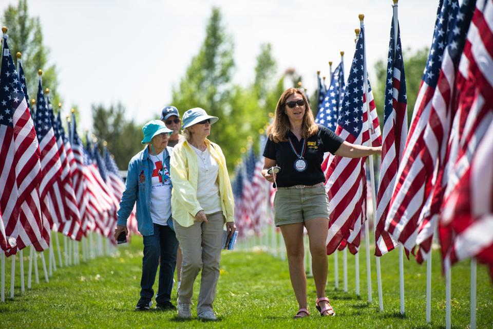 A group visits the Field of Honor display in Spring Canyon Community Park in Fort Collins on May 27, 2023.