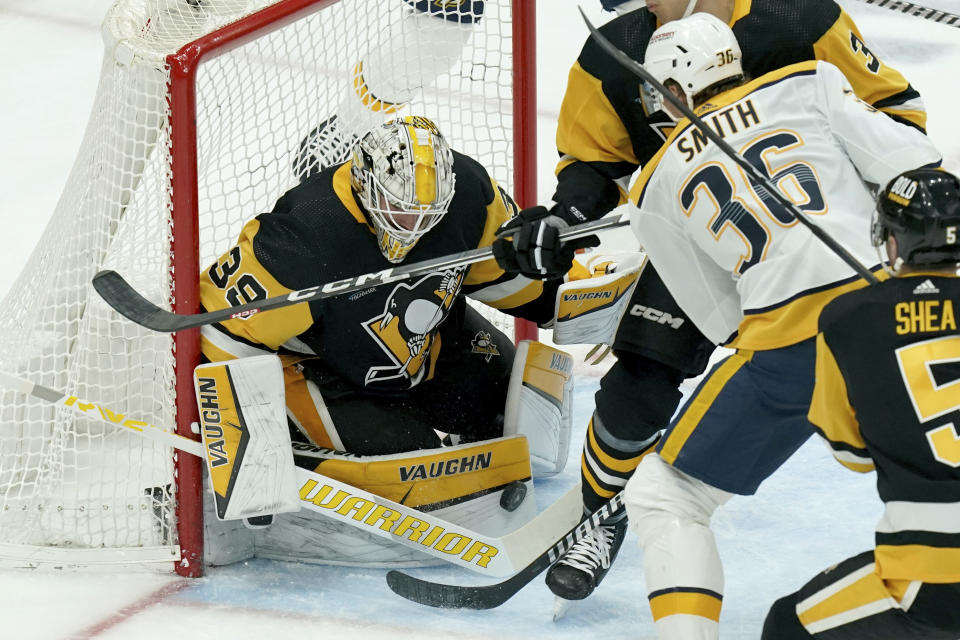 Pittsburgh Penguins goaltender Alex Nedeljkovic (39) makes a save against Nashville Predators' Cole Smith (36) during the first period of an NHL hockey game, Monday, April 15, 2024, in Pittsburgh. (AP Photo/Matt Freed)