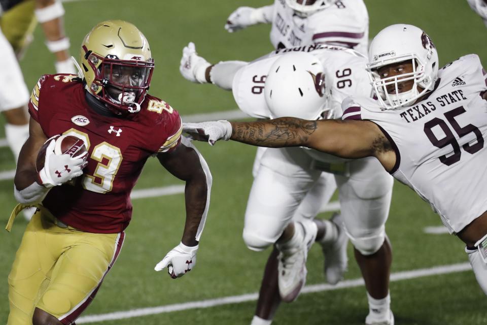 Texas State defensive lineman Nico Ezidore, right, tries to stop Boston College running back Travis Levy during their 2020 game. Ezidore will play his 56th and final game Saturday, one of 19 seniors who'll be honored by the Bobcats.