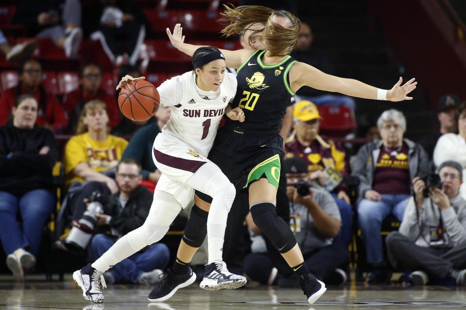 Arizona State guard Reili Richardson (1) collides with Oregon's Sabrina Ionescu (20) during the second half of an NCAA college basketball game Friday, Jan. 10, 2020, in Tempe, Ariz. Arizona State defeated No. 2 Oregon 72-66. (AP Photo/Ralph Freso)