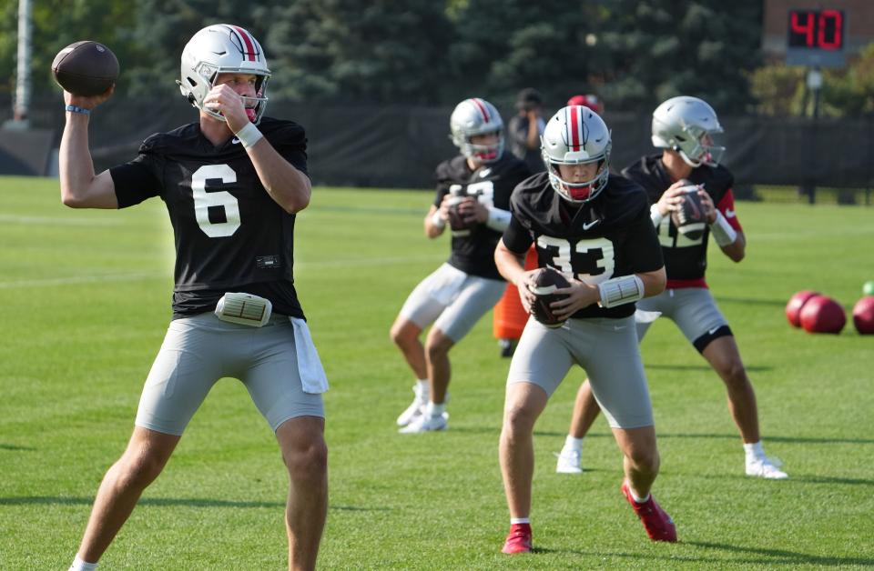 Aug 3, 2023; Columbus, OH, USA; The Ohio State quarterback position is unsettled this year: competing for the job is (from left) sophomore Devin Brown (6), junior Kyle McCord (33), freshman Lincoln Kienholz (12) and senior Tristan Gebbia (13). They were doing drills during the first football practice of the 2023 season at the Woody Hayes Athletic Center. Mandatory Credit: Doral Chenoweth-The Columbus Dispatch