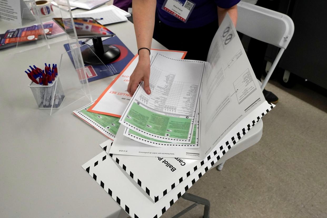 A poll worker assembles a ballot at Frank McCourt High School in New York on Tuesday, June 22, 2021.