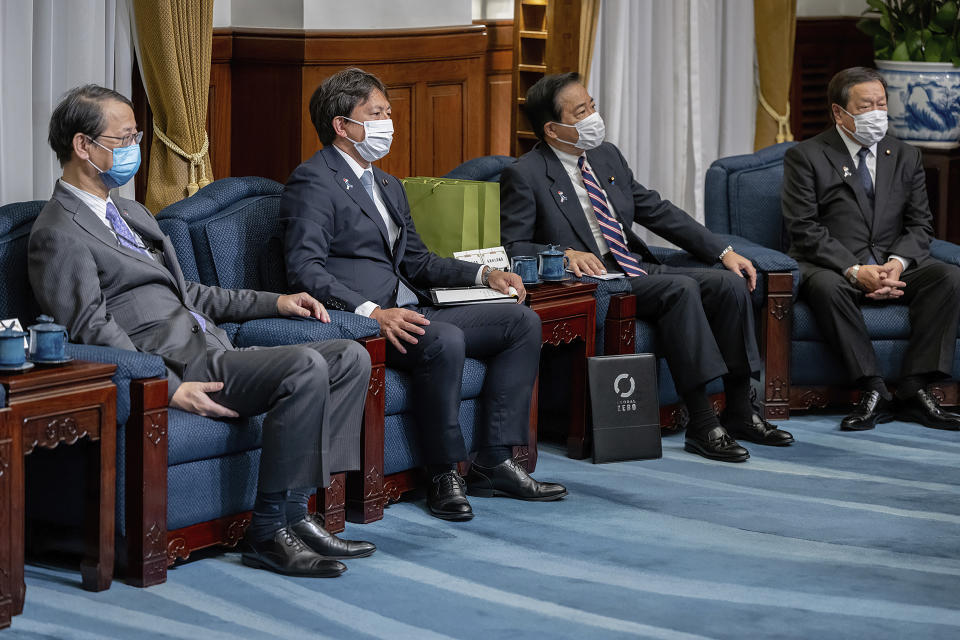 In this photo released by the Taiwan Presidential Office, Japanese lawmakers attend a meeting with Taiwan's President Tsai Ing-wen, unseen, at the presidential office in Taipei, Taiwan on Thursday, July 28, 2022. The group of Japanese lawmakers including two former defense ministers met with Taiwan's president on Thursday in a rare high-level visit to discuss regional security. (Taiwan Presidential Office via AP)