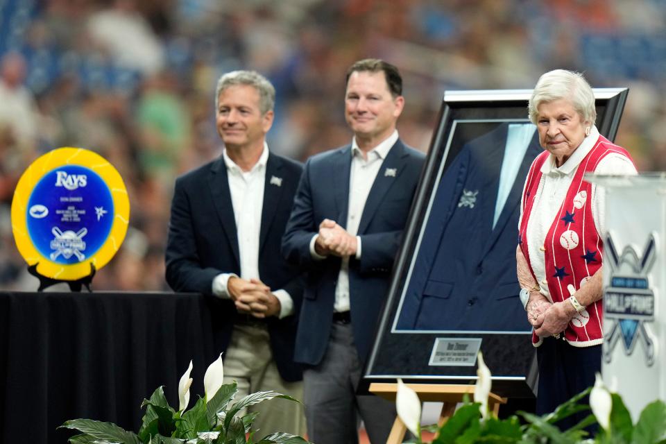 Soot Zimmer, wife of the late player and coach Don Zimmer, stands with Tampa Bay Rays owner Stu Sternberg, left, and team president Brian Auld, after Don was inducted in the Rays Hall of Fame before a baseball game between the Rays and the Detroit Tigers Sunday, April 2, 2023, in St. Petersburg, Fla.
