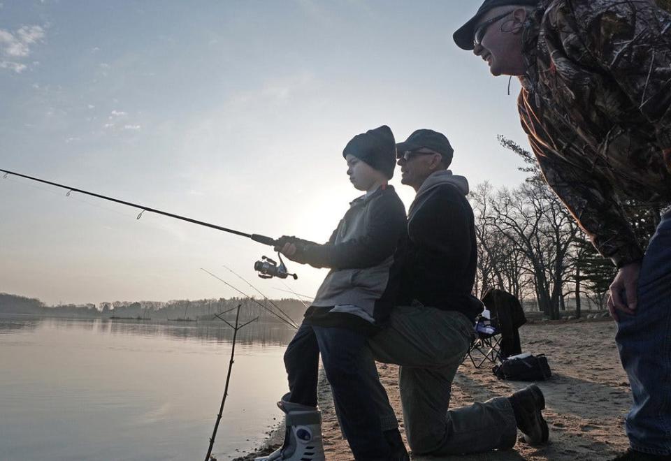 Grady LaMarche of North Kingstown gets help from both of his grandfathers on Opening Day of the trout-fishing season in April 2018 at Olney Pond in Lincoln Woods. Next to Grady is John McDermott of Cranston, and at right is Bob LaMarche of Warwick.